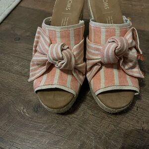 Size 5.5 super cute Toms.  Shoes are NWOT never wor. 3.5 wedge heel.